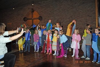 Ökumenischer Gottesdienst zur Schöpfung Kinder mit bunten Tüchern in den Händen feiern in einer Kirche einen Gottesdienst zum Tag der Schöpfung mit.